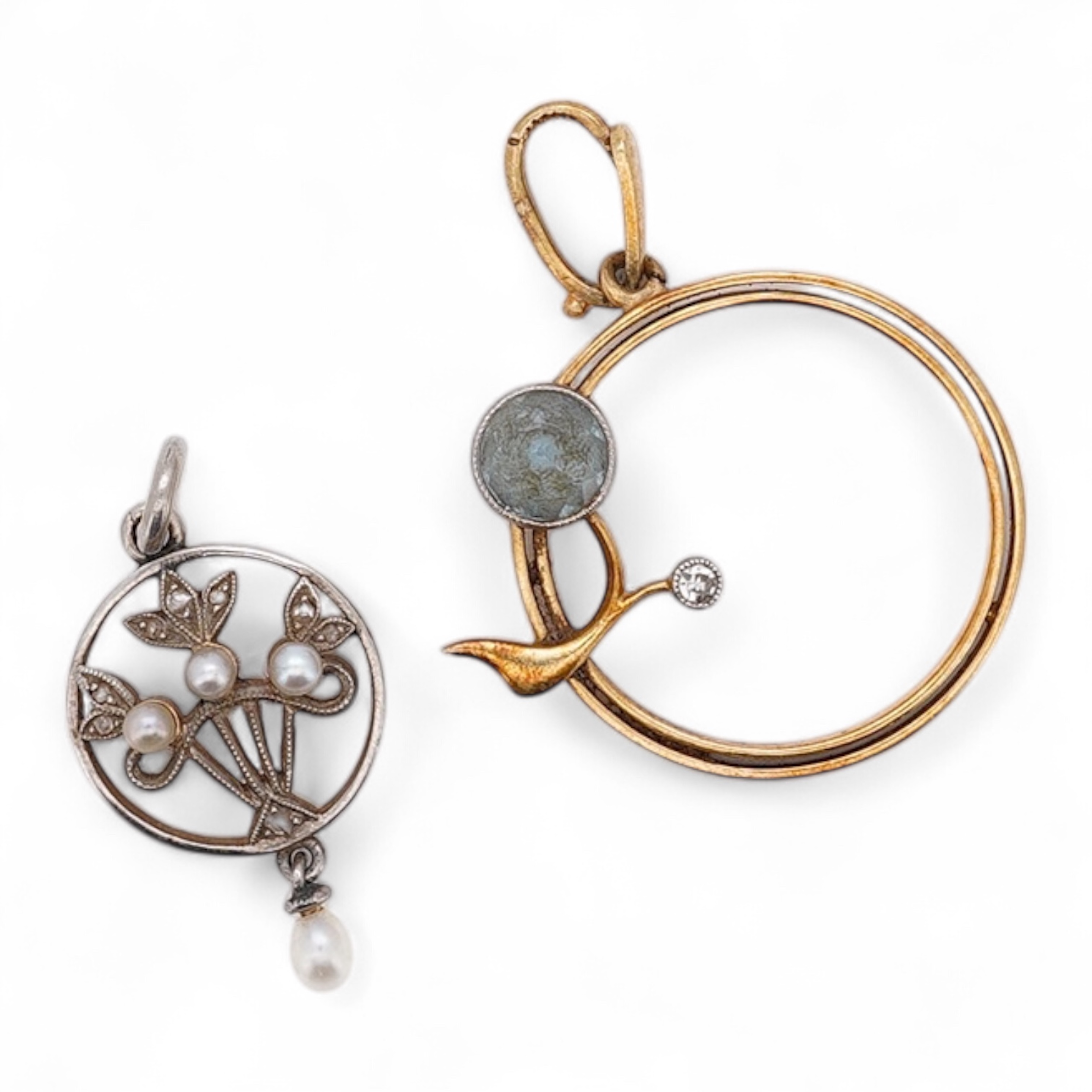 An early 20th century yellow metal, diamond chip and seed pearl set drop pendant, overall 23mm, together with a similar yellow metal, diamond and gem set open work pendant, diameter 20mm, gross weight 3.7 grams. Conditio